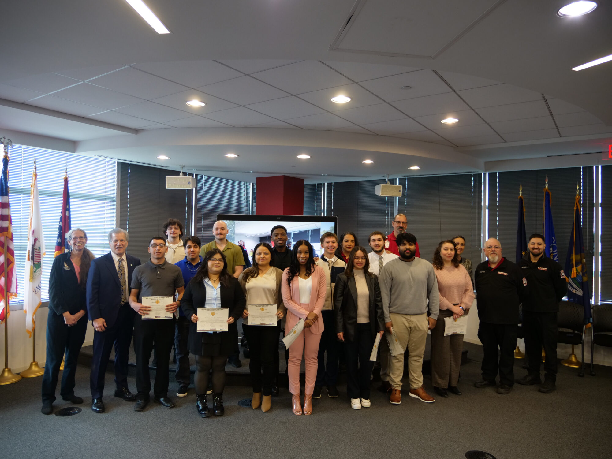 Elmhurst EMT Graduation March 2026 Group of EMT graduates pose for a photo with their instructors and local government officials